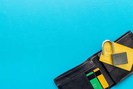 credit card hacked. open lock, wallet on blue table top-down space for textの写真素材
