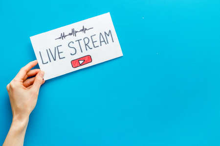 Live streaming web network concept. Female hands holding paper tablet. Top viewの写真素材