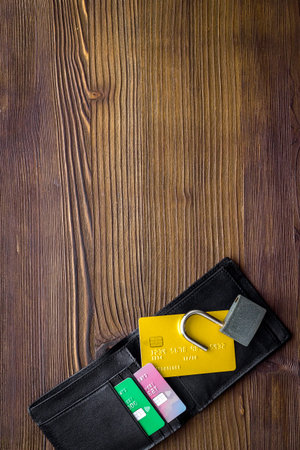 credit card hacked. open lock, wallet on wooden table top-down copy space