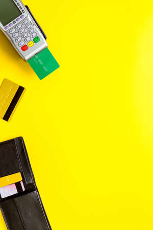 Payment by credit card. Terminal on yellow background top-down copy spaceの写真素材