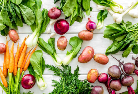 Carrot, potato, beet, onion and spinach on white background top viewの写真素材