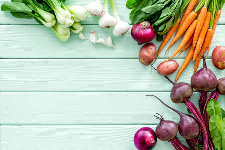 Vegetables harvest with green tops on green table top view frame copy spaceの写真素材