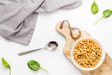 Raw chickpeas in bowl on white kitchen table top viewの写真素材