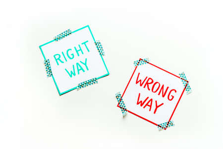 Problem solving. Right and wrong way icons on work desk from aboveの写真素材
