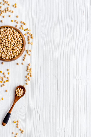 soy beans in bowl on white table top view copy space