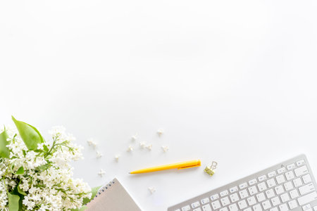 Top view of working space with jasmine flowers and computer keyboard