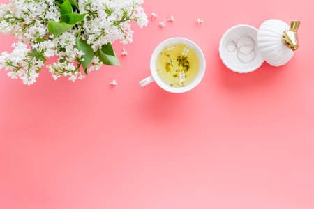 Jasmine flowers bouquet with tea on working office table desk. Top viewの写真素材