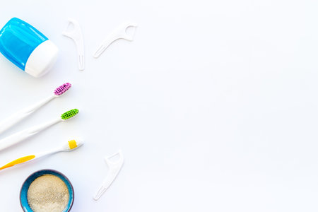 Concept of oral cleaning with toothbrushes, dental floss, tooth powder. Top view