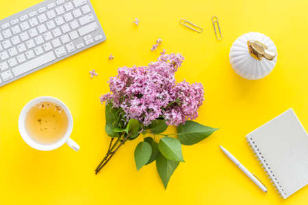 Lauout of computer and lilas flowers on bright working space. Top viewの写真素材