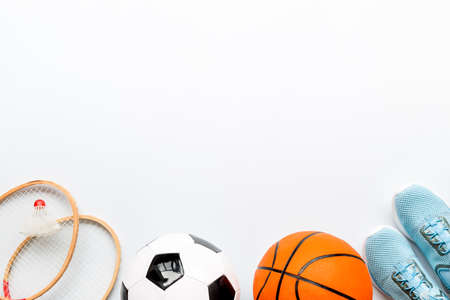 Flat lay of sport balls and rackets on white background. Above view, copy spaceの写真素材