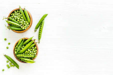 Bowl of green pea pod with beans on kitchen desk. Top viewの写真素材