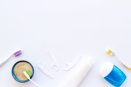 Concept of oral cleaning with toothbrushes, dental floss, tooth powder. Top view