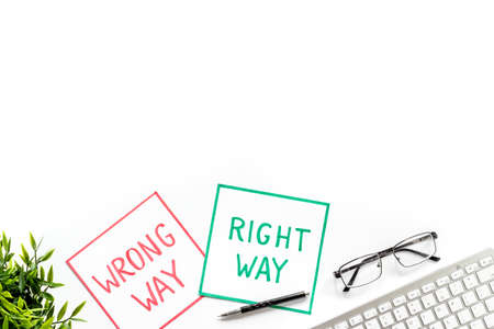 Doubt concept.. Right and wrong way icons on work desk from above copy spaceの写真素材