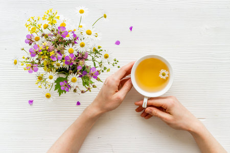 Wild flowers with herbal tea on a table top view, copy space