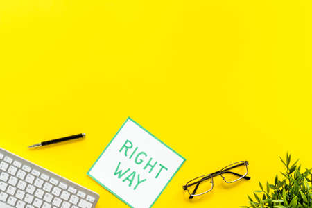 Right way icon on yellow office desk top view copy spaceの写真素材