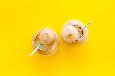 Raw coconut water or milk with straw, above viewの写真素材