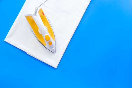 Household laundry ironing concept. Iron with clothes top viewの写真素材
