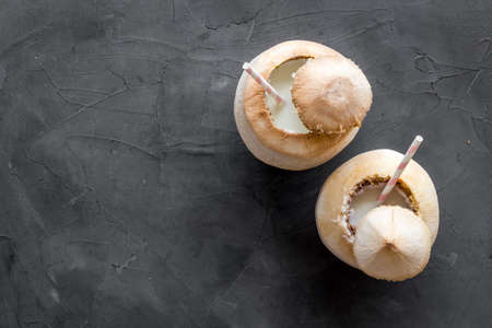 Raw coconut water or milk with straw, above viewの写真素材