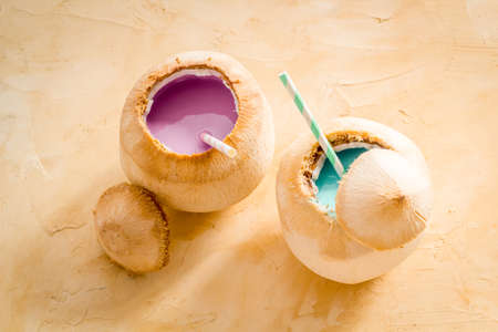 Drink in raw coconut with straw, top viewの写真素材