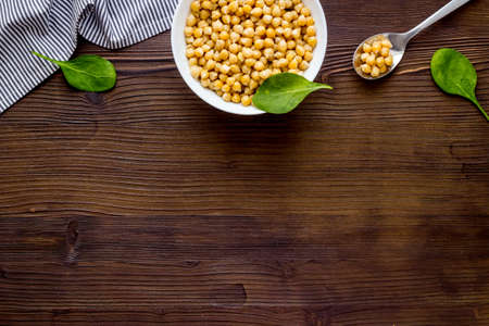 Raw chickpeas in bowl on wooden kitchen table from above copy spaceの写真素材