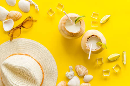 Tropical coconut drink with straw on beach background, top viewの写真素材