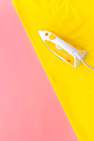 Household laundry ironing concept. Iron with clothes top viewの写真素材