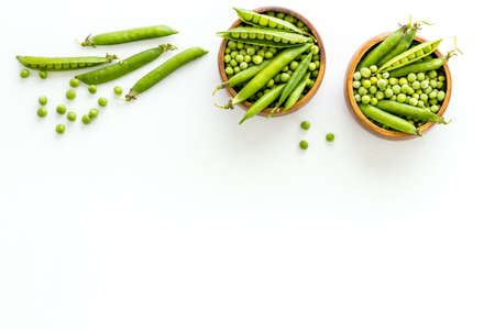 Bowl of green pea pod with beans on kitchen desk. Top viewの写真素材