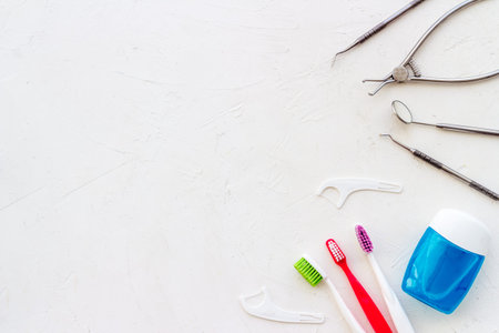 Concept of oral cleaning with toothbrushes, dental floss, tooth powder. Top view