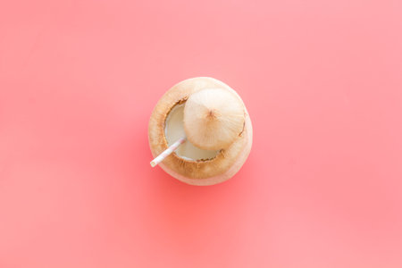 Green coconuts with drinking straw - tropical cocktail, above view