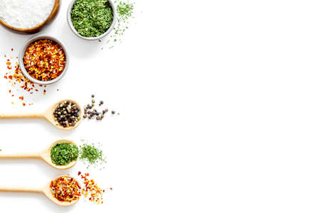 Spices and herbs in wooden spoons, food and cuisine ingredients. Top viewの写真素材