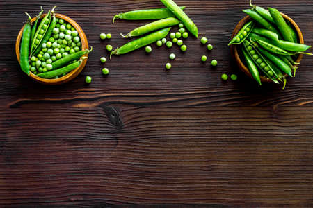 Bowl of green pea pod with beans on kitchen desk. Top viewの写真素材