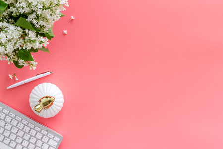 Workplace with laptop and flowers bouquet top view