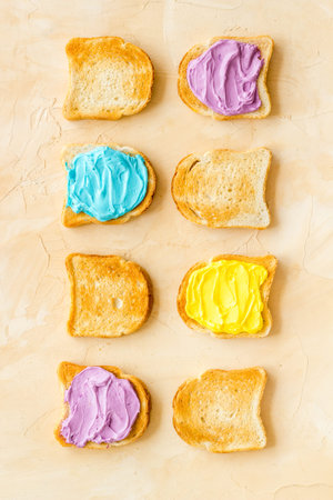 Set of slices toast bread with butter and cheese spread. Top view