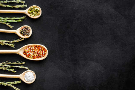 Spices and herbs in wooden spoons, food and cuisine ingredients. Top view