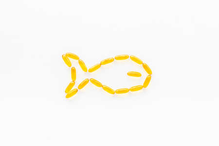 Omega3 capsules cod liver oil, fish shape. Top viewの写真素材