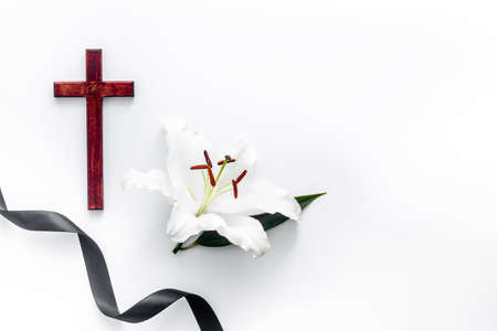 White lily with cross and black ribbon. Funeral conceptの写真素材