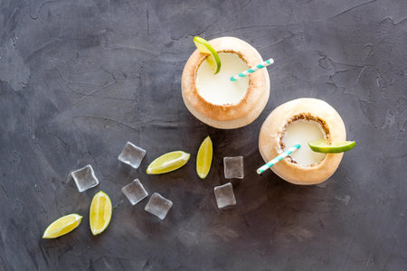 Green coconuts with drinking straw - tropical cocktail, above viewの写真素材