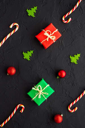 Dark Christmas layout with tree branches gifts and decorations