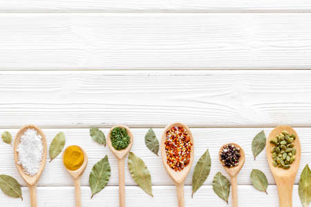 Spices and herbs in wooden spoons, food and cuisine ingredients. Top viewの写真素材