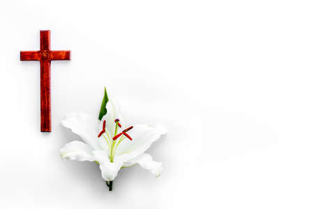 Lily funeral flower with cross. Condolence card with copy spaceの写真素材