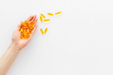 Omega fish cod liver oil capsules in hands, copy spaceの写真素材