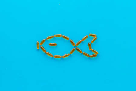Omega3 capsules cod liver oil, fish shape. Top viewの写真素材