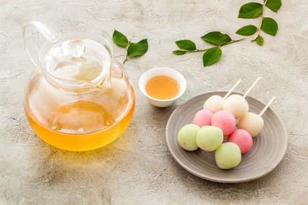 Japanese tea and sweet dumplings Dango on plate, close upの写真素材