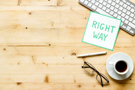 Right way icon on wooden office desk top view copy spaceの写真素材