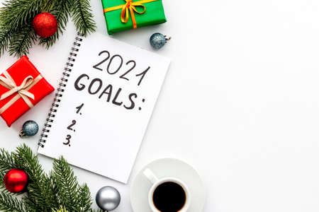 Inspiration concept - New Years goals written in notebook on a table, flat layの写真素材