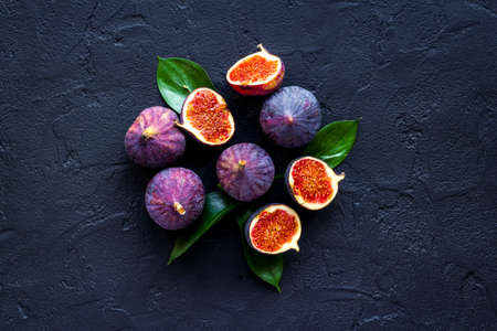 Tasty fresh figs cut in half with leaves, top viewの写真素材