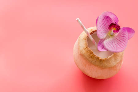Coconut drink with drinking straw, top viewの写真素材