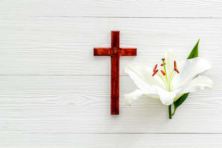 Lily funeral flower with cross. Condolence card with copy spaceの写真素材