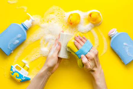Hands holding baby care products, view from aboveの写真素材