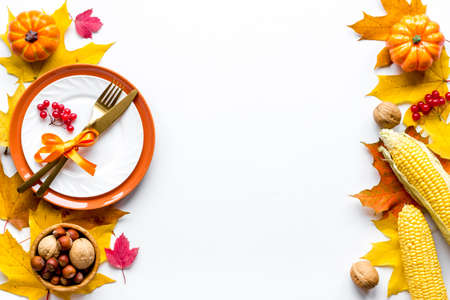 Thanksgiving holidays concept with dishes and pumpkins, top view